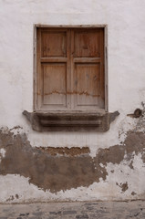 old window in disintegrating stone wall