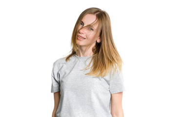 Fototapeta premium Portrait of a young happy woman who is waving her head and long hair isolated on a white background.