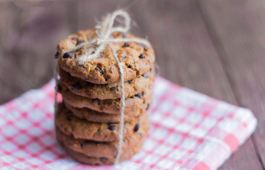 delicious crispy oatmeal cookies with chocolate chips on a napkin