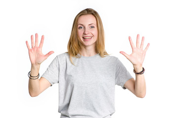 Portrait of a young happy woman showing ten fingers on two hands, isolated on white background.