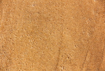 the texture of the wet sand with the water bubbles