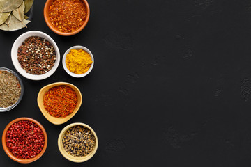 Collection of indian spices in bowls on background