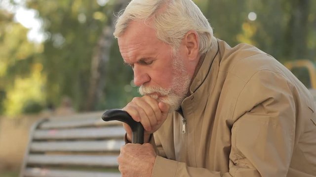 Sad, gloom gray-haired male slackening, feeling deplorable, helpless, powerless