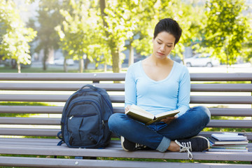 Obraz premium Shorthaired girl writing in notebook outdoors