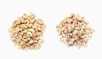 Piles of pistachio and cashew isolated on white