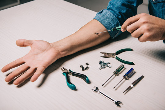 cropped view of man repairing hand with metallic tools