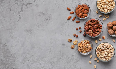 Variety of nuts on grey stone background
