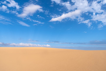 Fototapeta na wymiar Sand dune against sky
