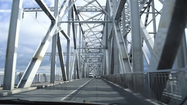 Driver's POV driving through the Bridge during a bright cloudy day.