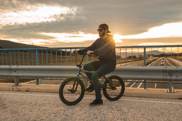 Young man riding a bmx bike. BMX rider. Extreme urban sports 