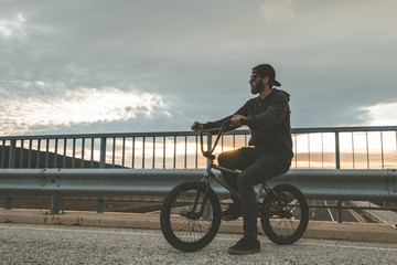 Young man riding a bmx bike. BMX rider. Extreme urban sports 