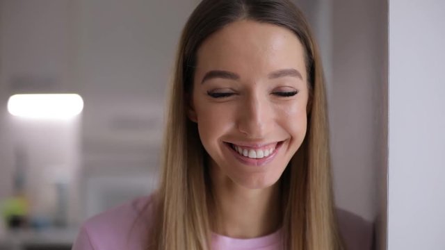 Young positive woman face smile at home in slow motion