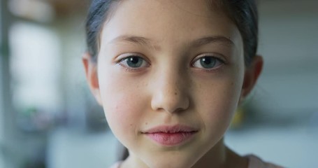 Close up portrait of a little girl with blue eyes looking in the camera on living room background. Shot with RED camera in 8K. Concept of childhood, kids protection, daughter, happy family - Powered by Adobe