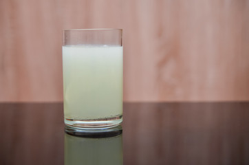 effervescent tablet dissolves in a glass of water on a black table