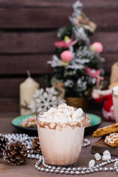 Hot cocoa with marshmallows in glasses  on a wooden table in Christmas decorations