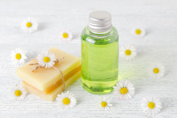 Fototapeta na wymiar natural hair shampoo, handmade soap bar with fresh chamomile flowers