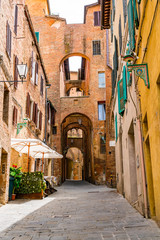 View of the beautiful street archway in the hill top town Siena