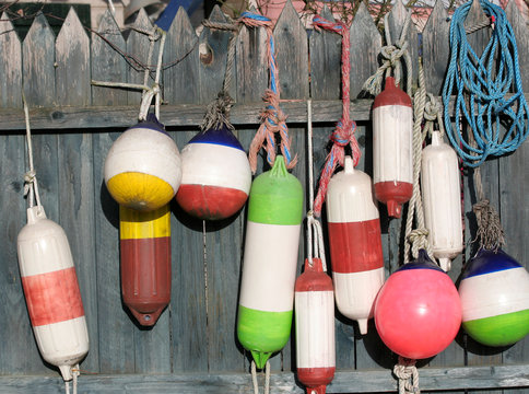 Colorful Plastic Buoys hanged to fence to dry