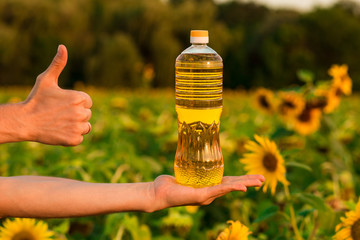 Man's hand hold bottle of sunflower oil. Sunflower oil improves skin health