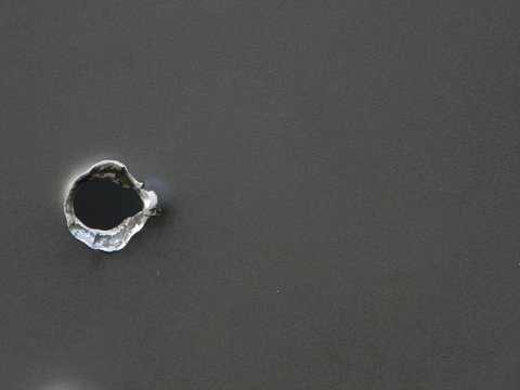 Bullet hole on steel plate