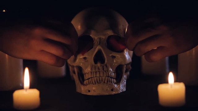 Magic ritual with skull and hearts