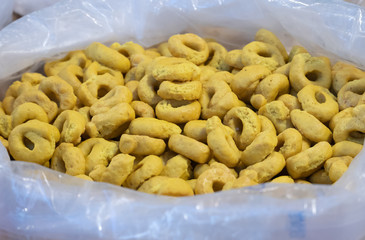 Close up of several baskets of Tarallucci with spices, like Saffron. Savory biscuits typical of southern Italy