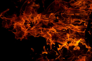 Fototapeta na wymiar Fire flames on Abstract art black background, Burning red hot sparks rise from large, Fiery orange glowing
