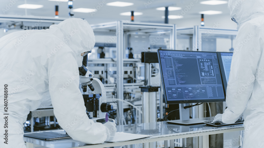 Poster in laboratory scientists in protective clothes doing research, using microscope and entering data in