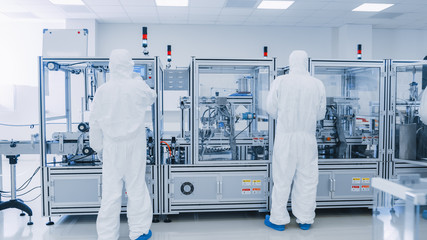 Manufacturing Laboratory where Scientists in Protective Coverall's Work with Industrial High...