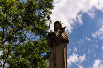 statue of the Madonna taken from the bottom and in the background the clouds