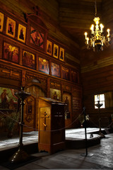 Wooden Orthodox church - icons on the iconostasis, you can see the pulpit, the choir, and the royal...