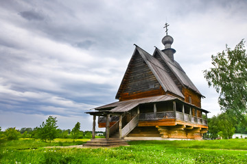 Ancient Russian wooden church under stormy sky