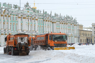 Snow-removal vehicles on the streets.