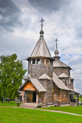 Fototapeta na wymiar Ancient Russian wooden church under stormy sky