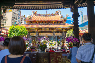 Crowd of people make a pray at Longshan Temple in Taipei, Taiwan