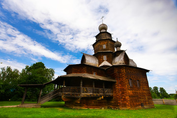 Wooden Orthodox church on green grass