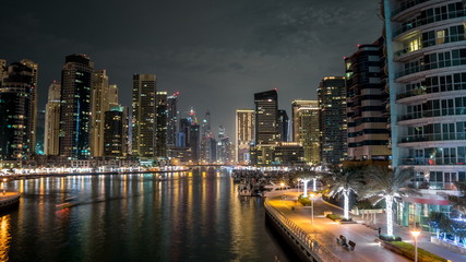 Fototapeta na wymiar Promenade in Dubai Marina timelapse hyperlapse at night, UAE.