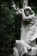 The Sorrowful Angel. Marble mourning angel with a cross, space for text