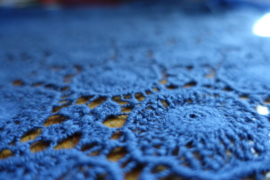 Details of blue lacy fabric on wood