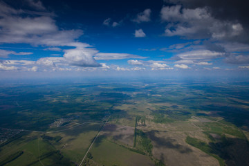 The flight under the blue sky over the summer plain.