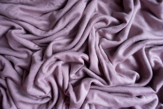Unprinted pink viscose fabric in soft folds from above