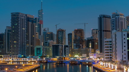 Obraz premium View of Dubai Marina Towers and canal in Dubai night to day timelapse