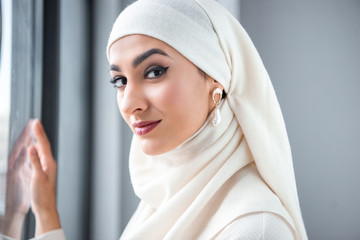 portrait of beautiful young muslim woman smiling at camera