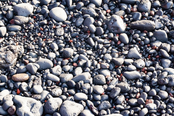 Black vulcanic stones on a black sand beach as a background, El Golfo, Lanzarote, Canary Islands, Spain
