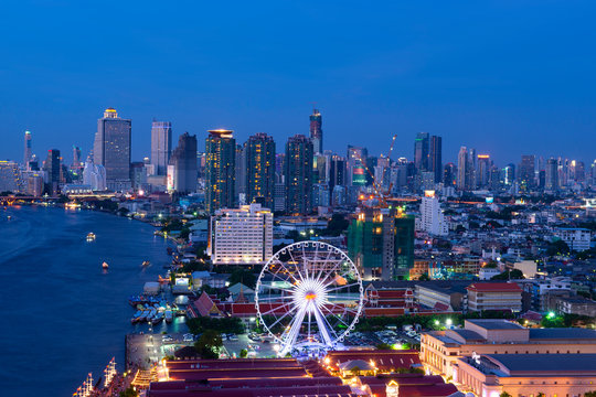 Bangkok skyline river view business and travel district at dusk blue hour.