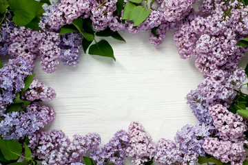 Fototapeta na wymiar Beautiful still life with violet lilac flower on wooden table