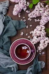 Obraz na płótnie Canvas Spring composition with lilac and tea cup