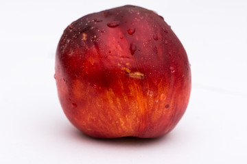 Washed peach with drops of water on the white background