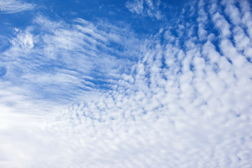 Blue sky background with a tiny clouds. Sunny day
