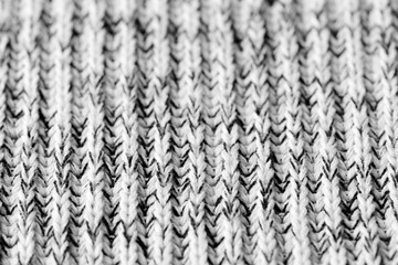White and black knitted woolen texture background close up